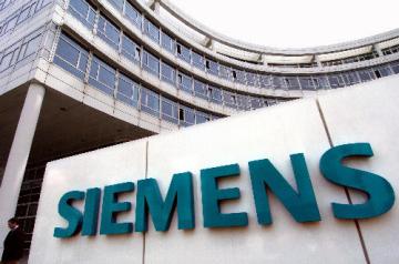 (dpa) - A view at the headquarter of Siemens AG, German electronics and technology company, with the writing 'SIEMENS' on it in Munich, Germany, 2 April 2004. Siemens is currently examining the option to relocate around 2,500 jobs abroad. Further restructuring and reduction of costs in seven of the 14 business devisions are planned, Siemens said on 1 April in Munich.