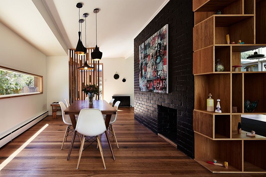 Dark-accent-brick-wall-fashions-a-dramatic-focal-point-inside-the-contemporary-dining-space